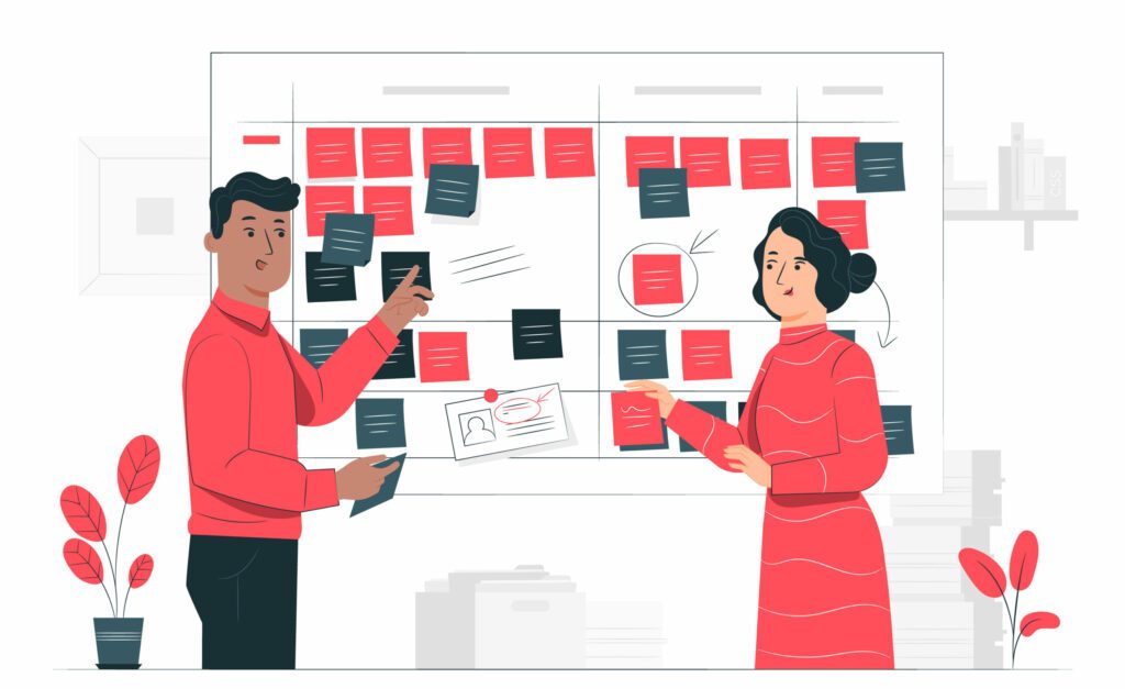 Two people pointing to a note board
